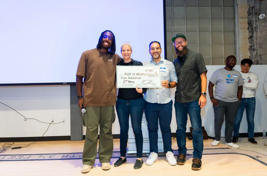 Paul Gunnels holding 2nd place check at OpenAI hackathon in Detroit